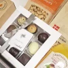 Økologisk gavekurv med sprøde knækbrød, chokolade og lemonade